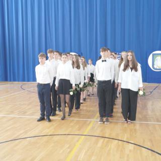 Uczniowie klas ósmych tańczący poloneza.